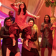 Iman Vellani's Kamala Khan dances atop the shoulders of two men at a Muslim wedding ceremony.